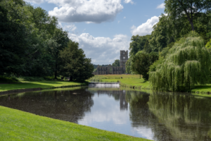 View of Fountains Abbey, showing reflection in Half-Moon Lake